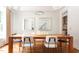 Bright dining room with a large wooden table, hardwood flooring, and contemporary decor at 105 Woodsage Way, Cary, NC 27518