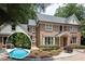 Beautiful brick home featuring a swimming pool, landscaped yard, and classic architectural details at 105 Woodsage Way, Cary, NC 27518