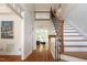Elegant foyer featuring hardwood floors, a grand staircase, and an open view to the living space at 105 Woodsage Way, Cary, NC 27518