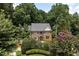 Attractive two-story brick home featuring a well-manicured lawn and blooming crape myrtle trees at 105 Woodsage Way, Cary, NC 27518