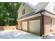 Spacious three-car garage with American flags, and ample parking space at 105 Woodsage Way, Cary, NC 27518