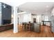Open-concept kitchen and living area with a kitchen island, modern appliances, and hardwood floors at 105 Woodsage Way, Cary, NC 27518