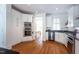 Bright kitchen with white cabinets, stainless steel appliances, granite countertops, and hardwood flooring at 105 Woodsage Way, Cary, NC 27518
