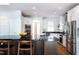 Spacious kitchen featuring stainless steel appliances, granite countertops, white cabinets, an island, and hardwood flooring at 105 Woodsage Way, Cary, NC 27518