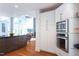 Bright kitchen with white cabinets, stainless steel appliances, a kitchen island, and hardwood flooring at 105 Woodsage Way, Cary, NC 27518