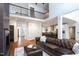 Spacious open-plan living room and kitchen with hardwood floors, white cabinets, and great natural light at 105 Woodsage Way, Cary, NC 27518