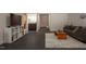 Open living room with sleek tile flooring, a comfortable sofa, and a modern entertainment setup at 105 Woodsage Way, Cary, NC 27518