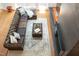 Comfortable living room featuring hardwood floors, area rug, and fireplace with tile surround at 105 Woodsage Way, Cary, NC 27518