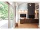 Bright and airy living space with hardwood floors, a modern fireplace, and sliding door to the patio at 105 Woodsage Way, Cary, NC 27518
