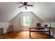 Home office space featuring hardwood floors, natural light, and a modern desk with office chair at 105 Woodsage Way, Cary, NC 27518