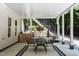 Covered patio area with a table, chairs, and stairs to upper deck at 105 Woodsage Way, Cary, NC 27518