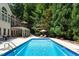 Backyard pool area with lounge chairs and well-manicured landscaping at 105 Woodsage Way, Cary, NC 27518