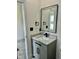 Elegant bathroom vanity featuring a granite countertop, modern fixtures, and a stylish, lighted mirror at 106 Viola Ln, Franklinton, NC 27525