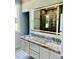 Bathroom featuring double sink with granite countertop and an illuminated mirror at 106 Viola Ln, Franklinton, NC 27525