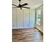 Bedroom with wood accent wall, fan, hardwood floors, and natural light from a window at 106 Viola Ln, Franklinton, NC 27525