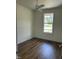 Bright bedroom features a ceiling fan and a window with a view of the yard at 106 Viola Ln, Franklinton, NC 27525