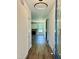 Hallway with hardwood floors, modern light fixture, leading to the living room with fireplace at 106 Viola Ln, Franklinton, NC 27525