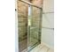 Modern shower with glass door and stone tile surround, next to a towel rack at 106 Viola Ln, Franklinton, NC 27525
