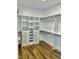 Spacious walk-in closet with custom shelving, drawers, and hardwood floors at 106 Viola Ln, Franklinton, NC 27525