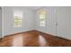 Bedroom with hardwood floors, windows for natural light, and neutral-painted walls at 1108 Taylor Street, Durham, NC 27701