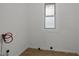Utility room with vinyl tile floor, window for natural light, and washer hookups at 1108 Taylor Street, Durham, NC 27701
