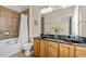 Bathroom with double sink vanity, granite countertop, and shower-tub combo at 111 Finsbury St, Durham, NC 27703