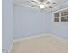 Bedroom with blue painted walls, carpet floors, and a ceiling fan at 111 Finsbury St, Durham, NC 27703