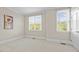 Bright bedroom with two windows, carpeted floors, and a painted accent wall at 111 Finsbury St, Durham, NC 27703