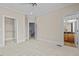 Large, carpeted bedroom featuring a ceiling fan and entry door to bathroom at 111 Finsbury St, Durham, NC 27703