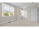 Carpeted bedroom featuring two windows and white door with white trim at 111 Finsbury St, Durham, NC 27703