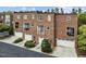 Exterior view of a row of brick townhomes, showcasing a two-car garage and balcony at 111 Finsbury St, Durham, NC 27703