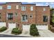 Rear exterior of townhomes featuring garages and second story balconies, with neat landscaping at 111 Finsbury St, Durham, NC 27703