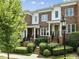 Beautiful brick townhome with manicured landscaping, a welcoming front porch, and classic architectural details at 111 Finsbury St, Durham, NC 27703