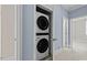 Closet including a stacked white washer and dryer at 111 Finsbury St, Durham, NC 27703