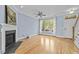 Bright living room with hardwood floors, fireplace, and large windows providing natural light at 111 Finsbury St, Durham, NC 27703