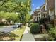 Pleasant street view showcasing the townhome community with sidewalks, street parking, and mature trees at 111 Finsbury St, Durham, NC 27703