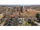 Aerial view showing a home nestled in a community with surrounding trees in varying colors of fall foliage at 112 Edgewood Dr, Roxboro, NC 27573