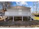This home features an elevated back porch with stairs to the backyard at 112 Edgewood Dr, Roxboro, NC 27573