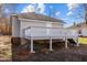 Back of home featuring a raised deck with white wood railings and a gray painted foundation at 112 Edgewood Dr, Roxboro, NC 27573