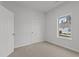 This carpeted bedroom features neutral paint, a large window, and a standard door at 112 Edgewood Dr, Roxboro, NC 27573