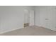 This spare bedroom has a standard closet, adjacent access, and neutral carpeting at 112 Edgewood Dr, Roxboro, NC 27573