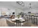 Open-concept living and dining area with modern lighting and stylish furnishings at 112 Edgewood Dr, Roxboro, NC 27573