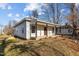 Single-story home featuring a cozy front porch and low-maintenance yard at 112 Edgewood Dr, Roxboro, NC 27573