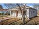 Exterior view of a home featuring a covered front porch with stained wood columns and two sconce lights at 112 Edgewood Dr, Roxboro, NC 27573