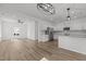 Open kitchen featuring stainless appliances, white cabinets, and plank flooring at 112 Edgewood Dr, Roxboro, NC 27573