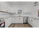 Modern kitchen featuring sleek white cabinetry, stainless steel appliances, and granite countertops at 112 Edgewood Dr, Roxboro, NC 27573
