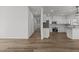 An open floor plan features plank flooring and connects the living room and kitchen at 112 Edgewood Dr, Roxboro, NC 27573