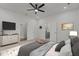 Bright main bedroom features a ceiling fan, neutral colors, and an ensuite bathroom at 112 Edgewood Dr, Roxboro, NC 27573