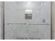 A tile and glass enclosed shower offers a built-in shelf and bench at 112 Edgewood Dr, Roxboro, NC 27573