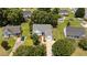 An aerial view of a charming home featuring a well-manicured lawn, mature trees, and a private driveway at 113 Kelly Ln, Clayton, NC 27520